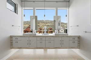Ensuite bathroom with double vanity and baseboards