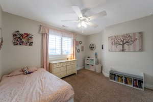Bedroom featuring dark colored carpet and a ceiling fan