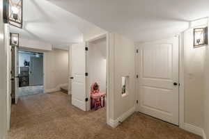 Game room featuring baseboards and light carpet
