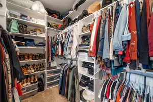 Walk in closet featuring light carpet