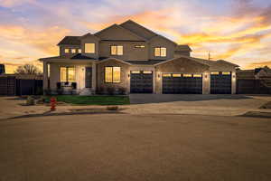 View of front of home with driveway, a gate, a porch, and an attached garage