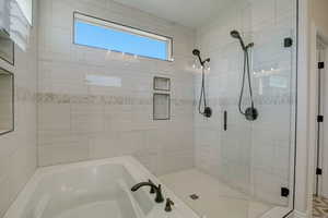 Bathroom with a garden tub and a shower stall