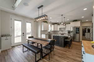Dining area featuring light wood-type flooring and recessed lighting