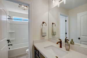 Bathroom with vanity and bathing tub / shower combination