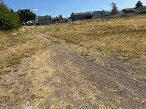 View of dirt / gravel road with a residential view