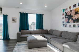 Living room featuring wood finished floors and recessed lighting