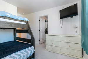 Bedroom featuring light colored carpet