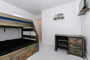 Bedroom with light carpet and baseboards