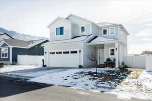 View of front of property featuring an attached garage and board and batten siding