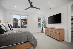 Bedroom with ceiling fan, light colored carpet, recessed lighting, and access to outside