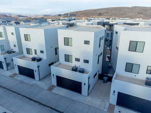 View of front of property with stucco siding, a mountain view, a residential view, and a patio