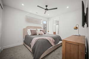 Bedroom with carpet, connected bathroom, recessed lighting, and a ceiling fan