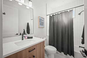 Bathroom with shower / tub combo, vanity, and light tile patterned floors