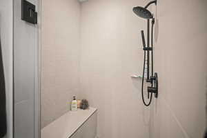 Full bathroom featuring a tile shower