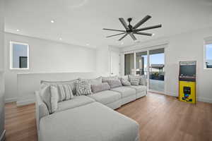 Living area featuring light wood-style flooring, recessed lighting, and ceiling fan