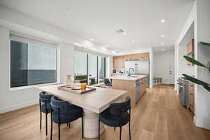 Dining space featuring light wood-style floors and recessed lighting