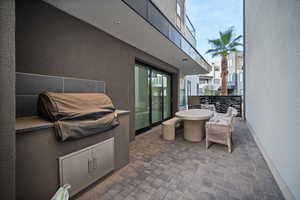 View of patio / terrace featuring exterior kitchen and outdoor dining space