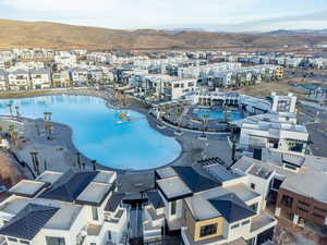 Aerial view of residential area with a pool and mountains