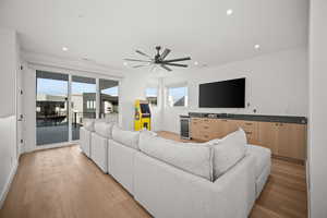 Living area featuring wine cooler, light wood finished floors, recessed lighting, and a ceiling fan