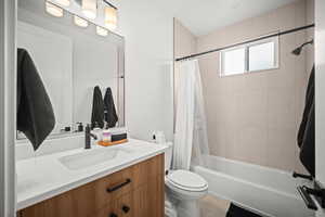Bathroom with vanity, shower / bath combo with shower curtain, and light tile patterned floors