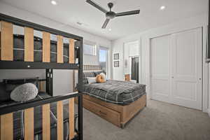 Bedroom with carpet, recessed lighting, a ceiling fan, ensuite bathroom, and a closet