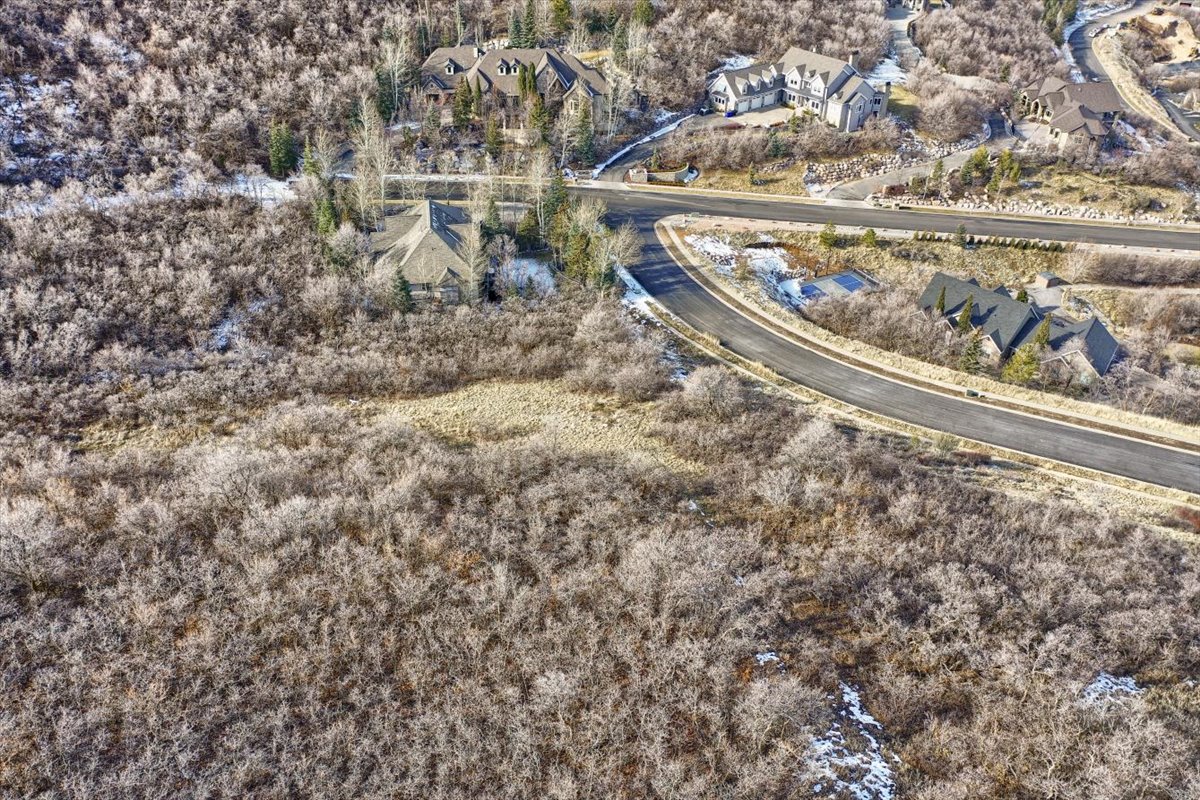 Aerial view of property and surrounding area featuring nearby suburban area