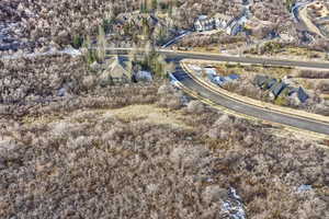 Aerial view of property and surrounding area featuring nearby suburban area
