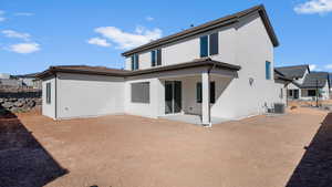 Rear view of property with a patio area and stucco siding