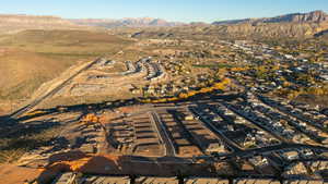 Aerial overview of property's location featuring a mountainous background and nearby suburban area