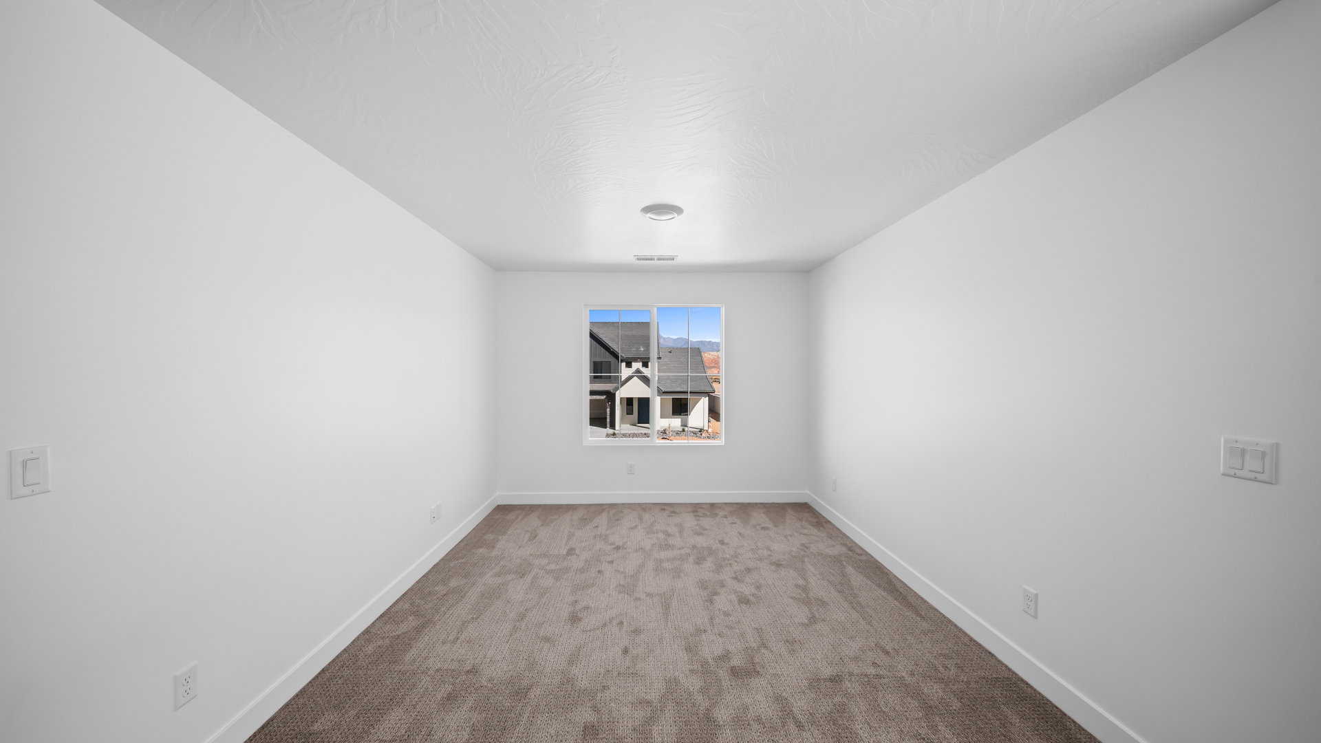 Carpeted spare room with baseboards