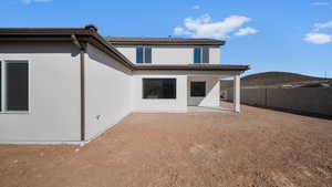 Rear view of property featuring stucco siding and a patio area
