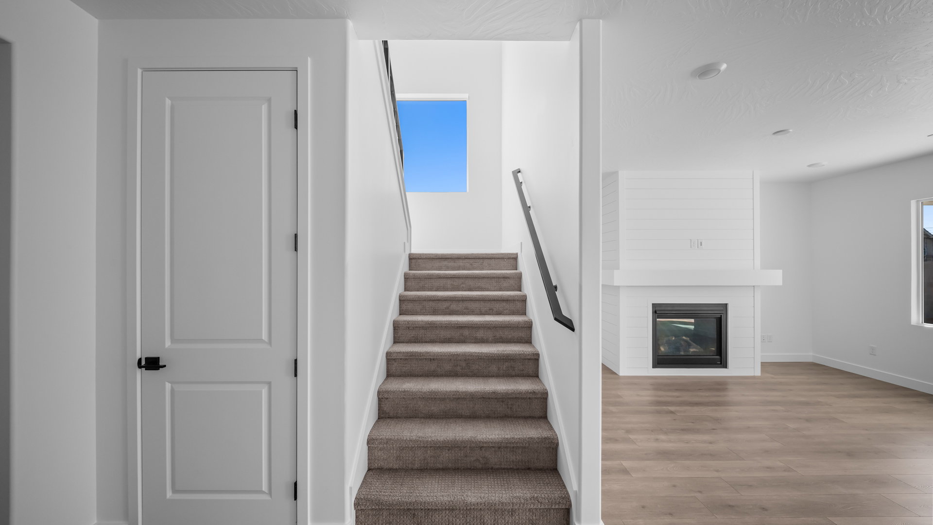 Stairs featuring a fireplace and wood finished floors