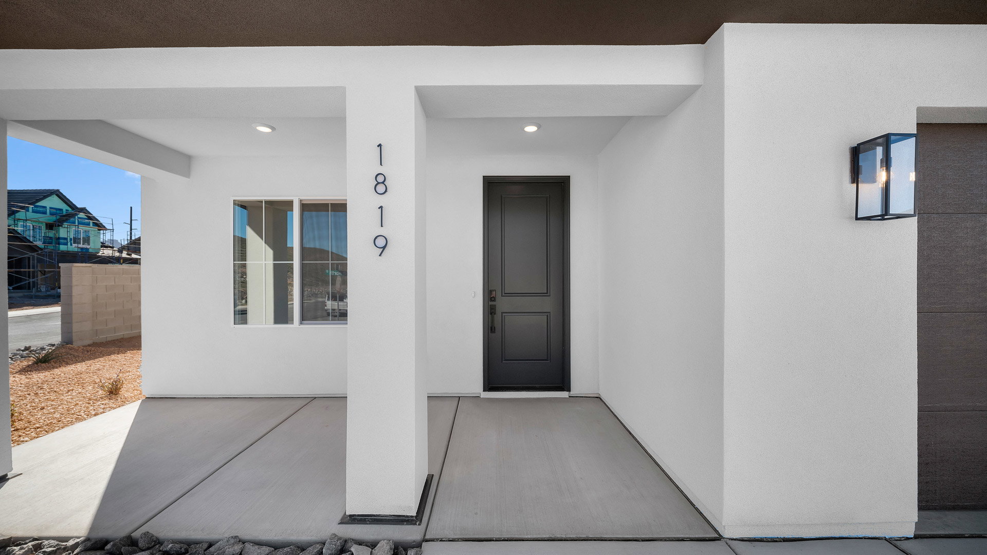 Property entrance featuring a porch and stucco siding