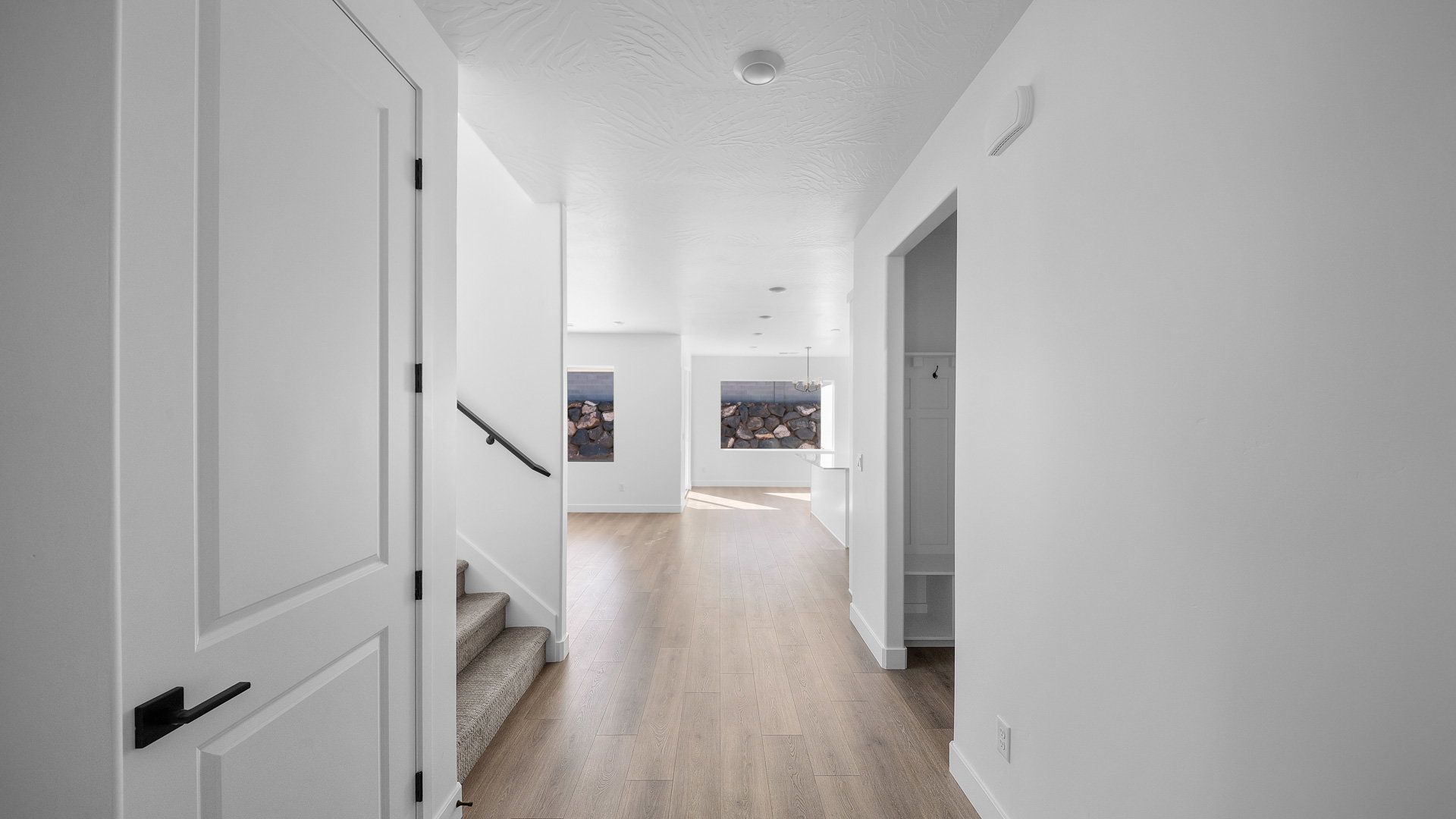 Corridor with stairway and light wood-type flooring