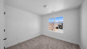 Empty room with light carpet and a mountain view