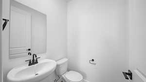 Half bathroom with toilet and a sink