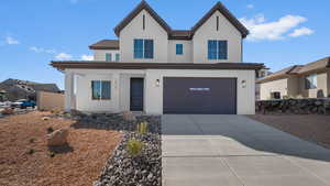 View of front facade with a porch, stucco siding, concrete driveway, and an attached garage