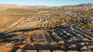 Aerial view of property's location with mountains and nearby suburban area