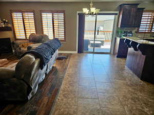 Living room featuring hanging lights and a fireplace