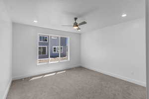 Carpeted empty room with a ceiling fan and recessed lighting