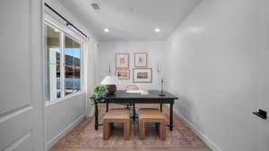 Office with baseboards and recessed lighting