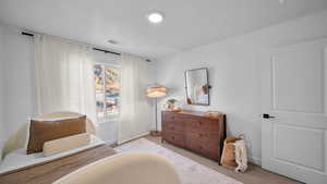 Bedroom featuring light colored carpet and baseboards