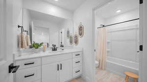 Full bath featuring vanity and shower / tub combo