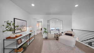 Sitting room with carpet flooring and recessed lighting