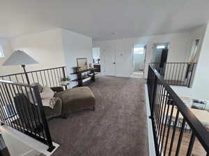 Living area with carpet flooring and baseboards