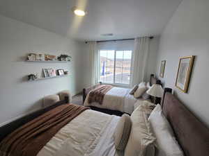 Carpeted bedroom featuring baseboards