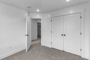 Unfurnished bedroom with carpet flooring and a closet