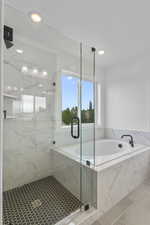 Full bathroom with a garden tub, a marble finish shower, and tile patterned flooring