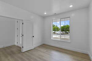 Unfurnished flex room with light wood-style flooring and recessed lighting
