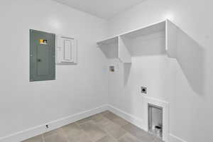 Laundry area with electric panel, hookup for a washing machine, and hookup for an electric dryer